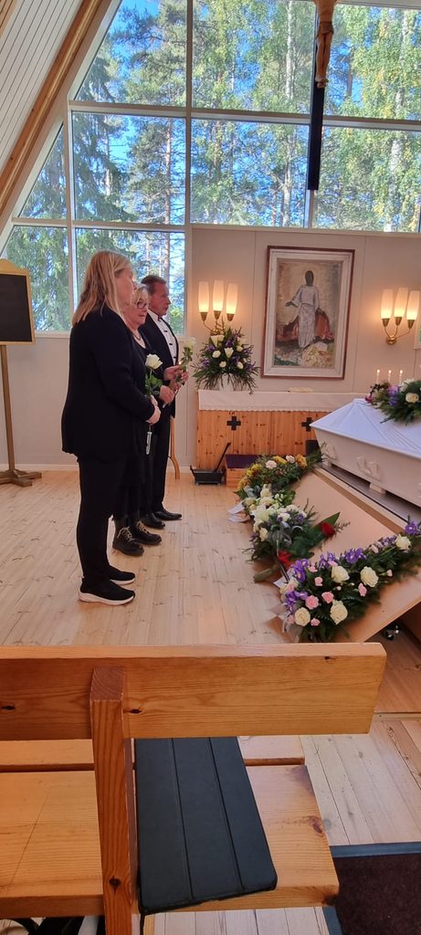 Kuolismaan Kettuset Sukuseuran perustajajäsenen Ensio Kettusen ( s. 21.10.1955 - k. 23.8.2026) siunaustilaisuudessa Ilomantsissa muistokukat laskemassa sukuseuran hallituksen jäsenet Jaakko Kettunen, Tuula Luomala ja Taina Koivisto